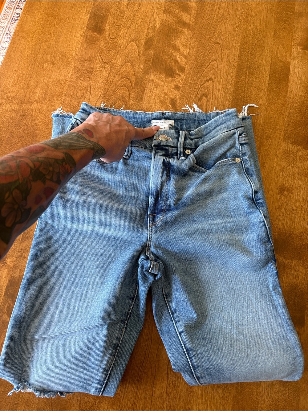 Good American ladies distressed jeans in a light wash.
